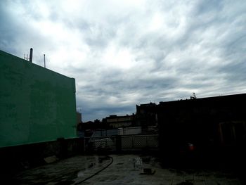 Building exterior against cloudy sky