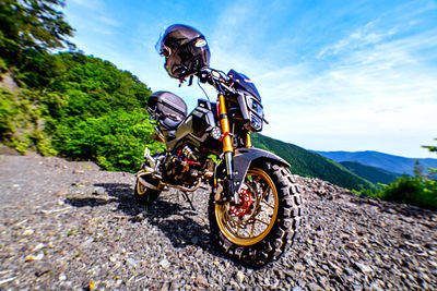 Rear view of man riding motorcycle on road