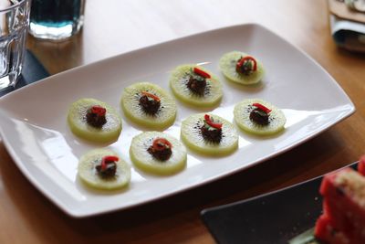 Kiwi fruits in plate on table