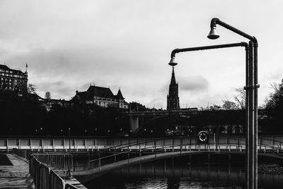 Bridge over river against buildings in city