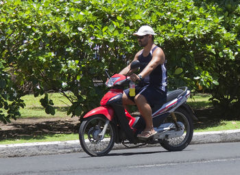 Man riding bicycle on road in city