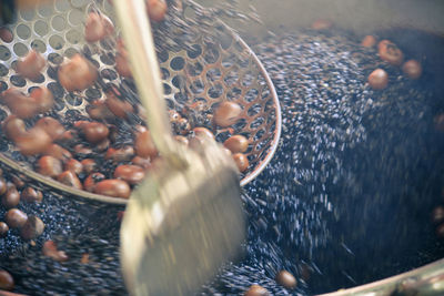 Blurred motion of roasting chestnut in container