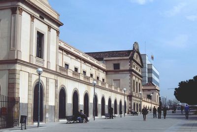 Buildings in city against blue sky