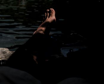 Low section of man lying in water