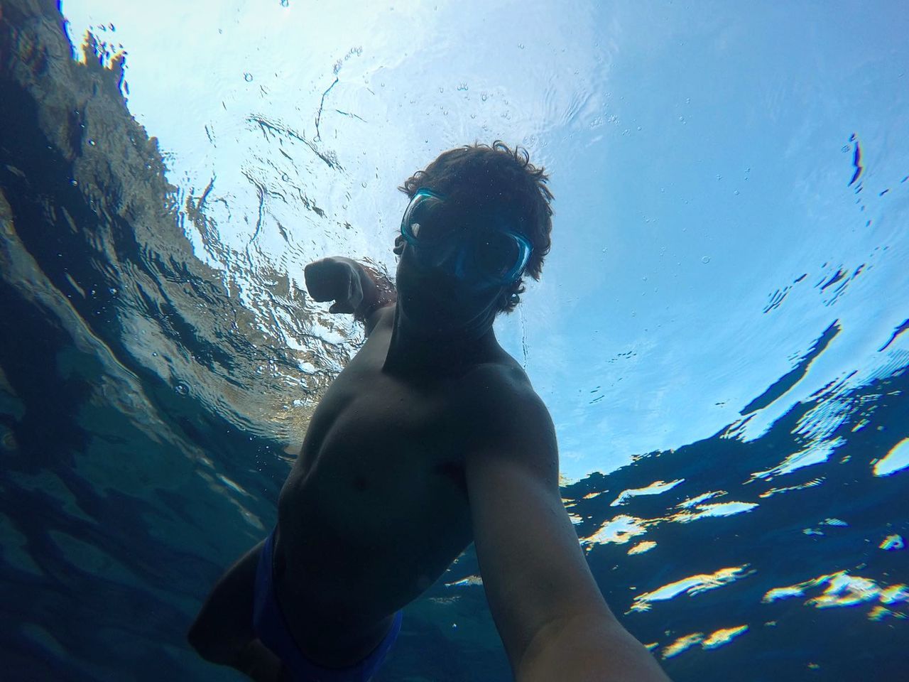 MAN STANDING IN SEA