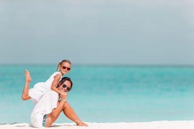 Portrait of mother and daughter at beach