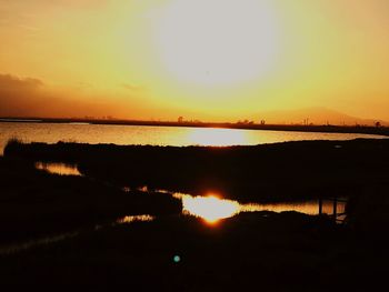 Scenic view of lake against sky during sunset