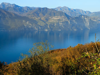 Scenic view of lake by mountains against sky