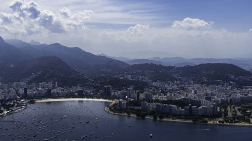 High angle view of river and buildings against sky