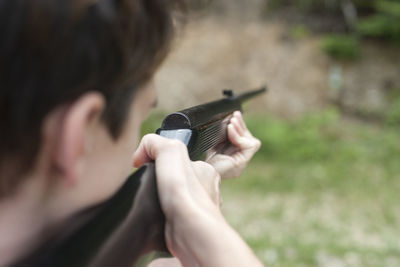 Close-up of man holding gun 