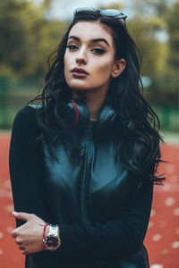 Portrait of young woman standing at basketball court