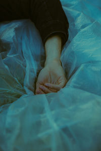 Close-up of woman lying on bed