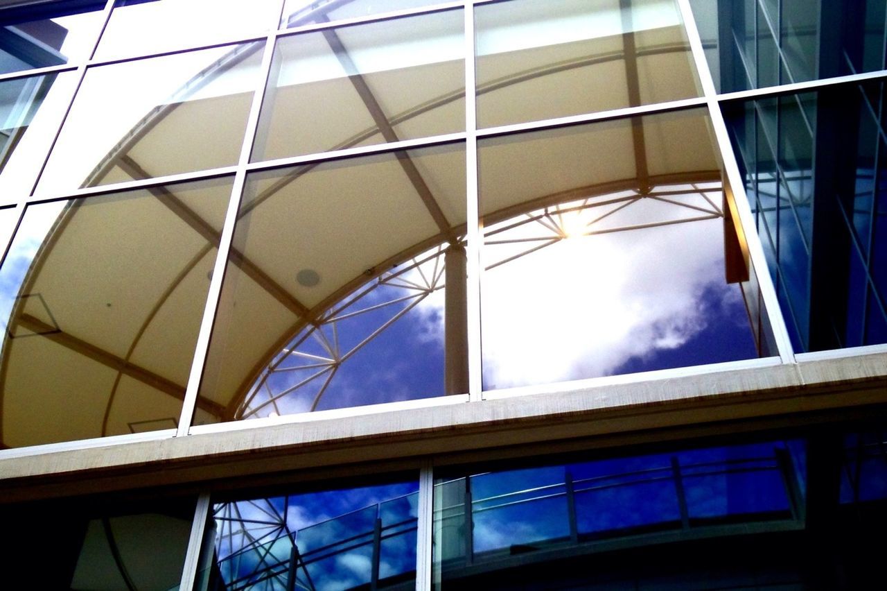 architecture, built structure, glass - material, low angle view, building exterior, modern, reflection, window, building, transparent, glass, office building, city, sky, skylight, indoors, day, directly below, no people, architectural feature