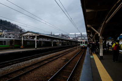 Train at railroad station against sky