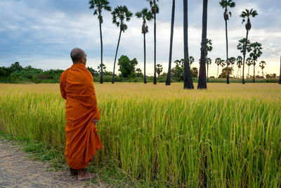 Rear view of man standing on field