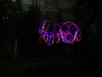 Illuminated light painting on land at night