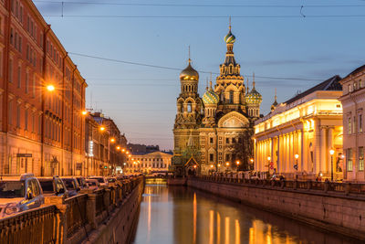 Illuminated buildings against sky in city