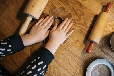 Girl making cookies on kitchen table