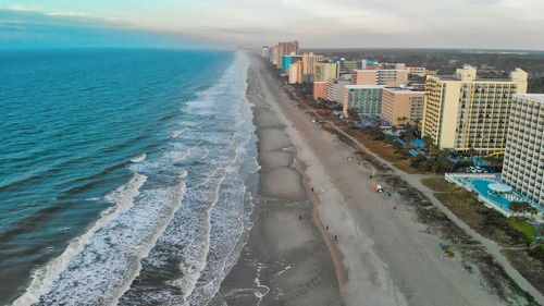 High angle view of beach and buildings against sky