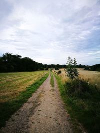 Dirt road along countryside landscape