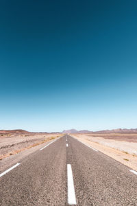 Scenic view of road against clear blue sky