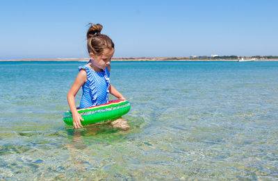 Girl with inflatable ring at beach