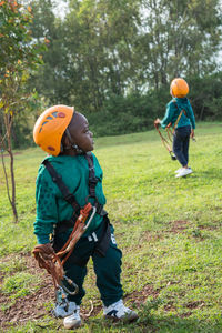 Rear view of boys standing on land