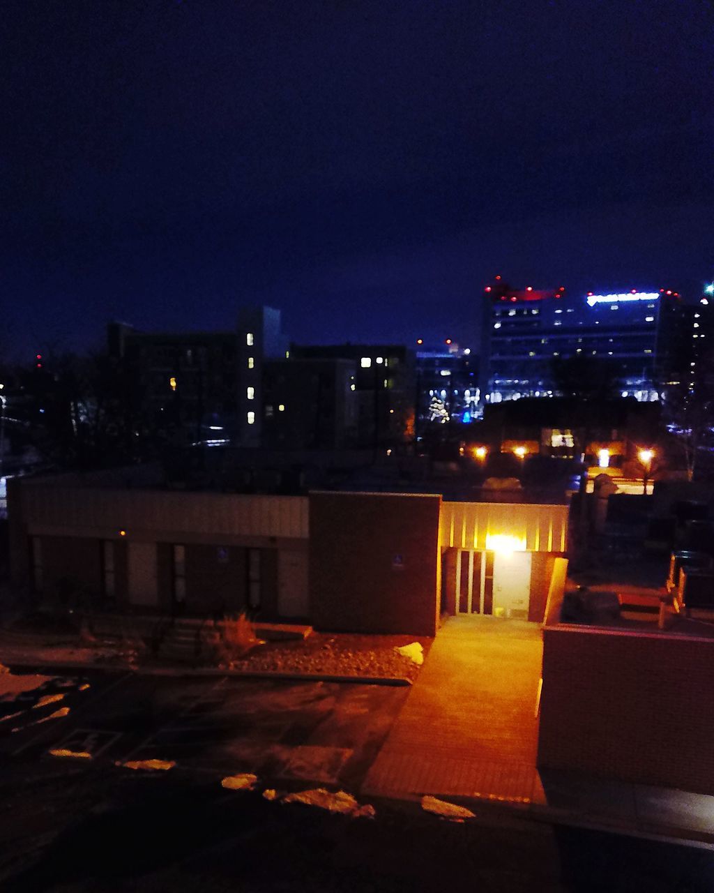 ILLUMINATED CITYSCAPE AGAINST SKY