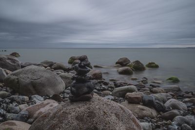 Rocks on beach against sky