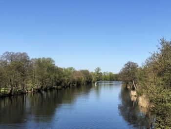 Scenic view of lake against clear blue sky