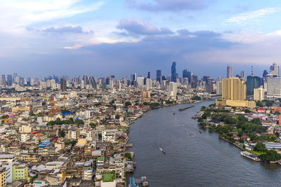 High angle view of buildings against cloudy sky