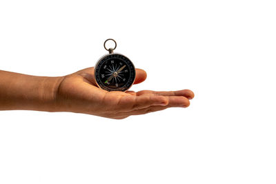 Midsection of person holding clock against white background