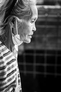 Side view of woman looking away outdoors