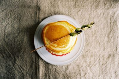 Directly above shot of pancakes in plate with leaf