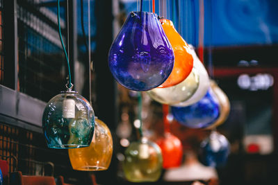 Close-up of multi colored lighting equipment hanging