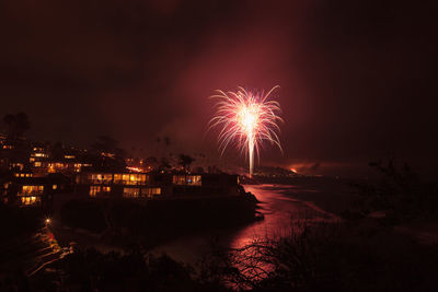 Firework display in city at night