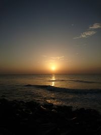 Scenic view of sea against sky at sunset