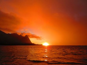 Scenic view of sea against orange sky