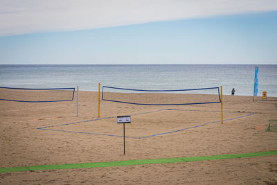 Beach volleyball court with blue sea and sky in the background. empty beach with clean sand