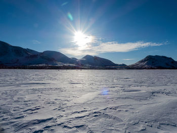 Scenic view of frozen sea against sky at sunset