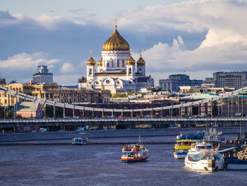 View of buildings in city against cloudy sky