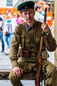 Portrait of soldier sitting outdoors