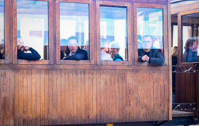 Men sitting on window