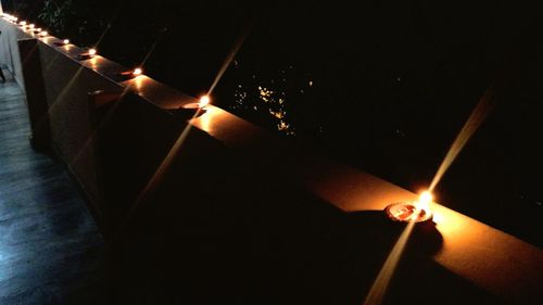 Lit candle in dark room