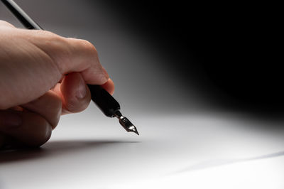 Close-up of hand writing on paper