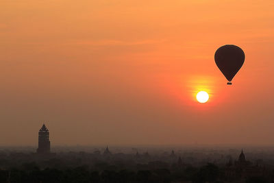 Silhouette of hot air balloon against sky during sunset
