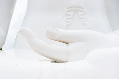 Low section of white shoes on table