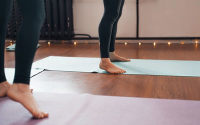 Low section of woman standing on hardwood floor