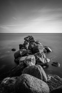 Stack of rocks on beach against sky