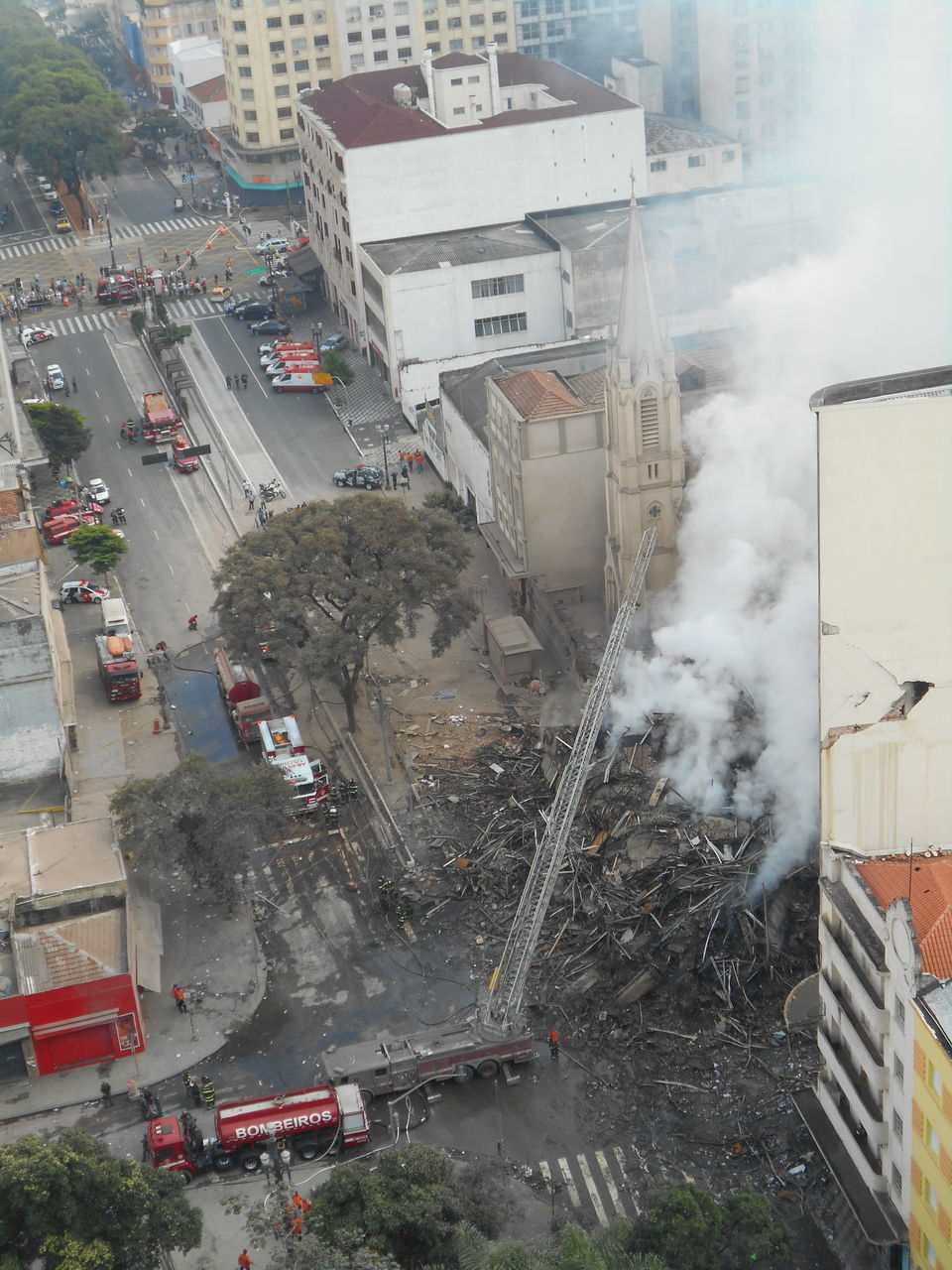 HIGH ANGLE VIEW OF STREET AMIDST BUILDINGS